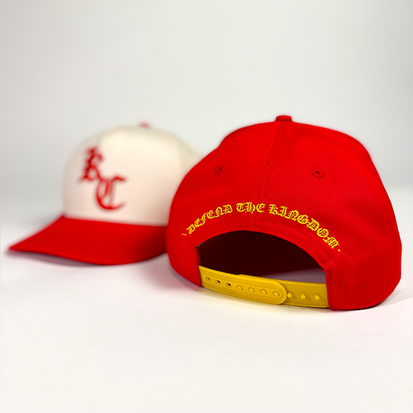 Red and off-white snapback hat with puff embroidery of an old english style KC. Also available in Red with yellow embroidery. 'Chrome Kingdom Hat' by Always Outside