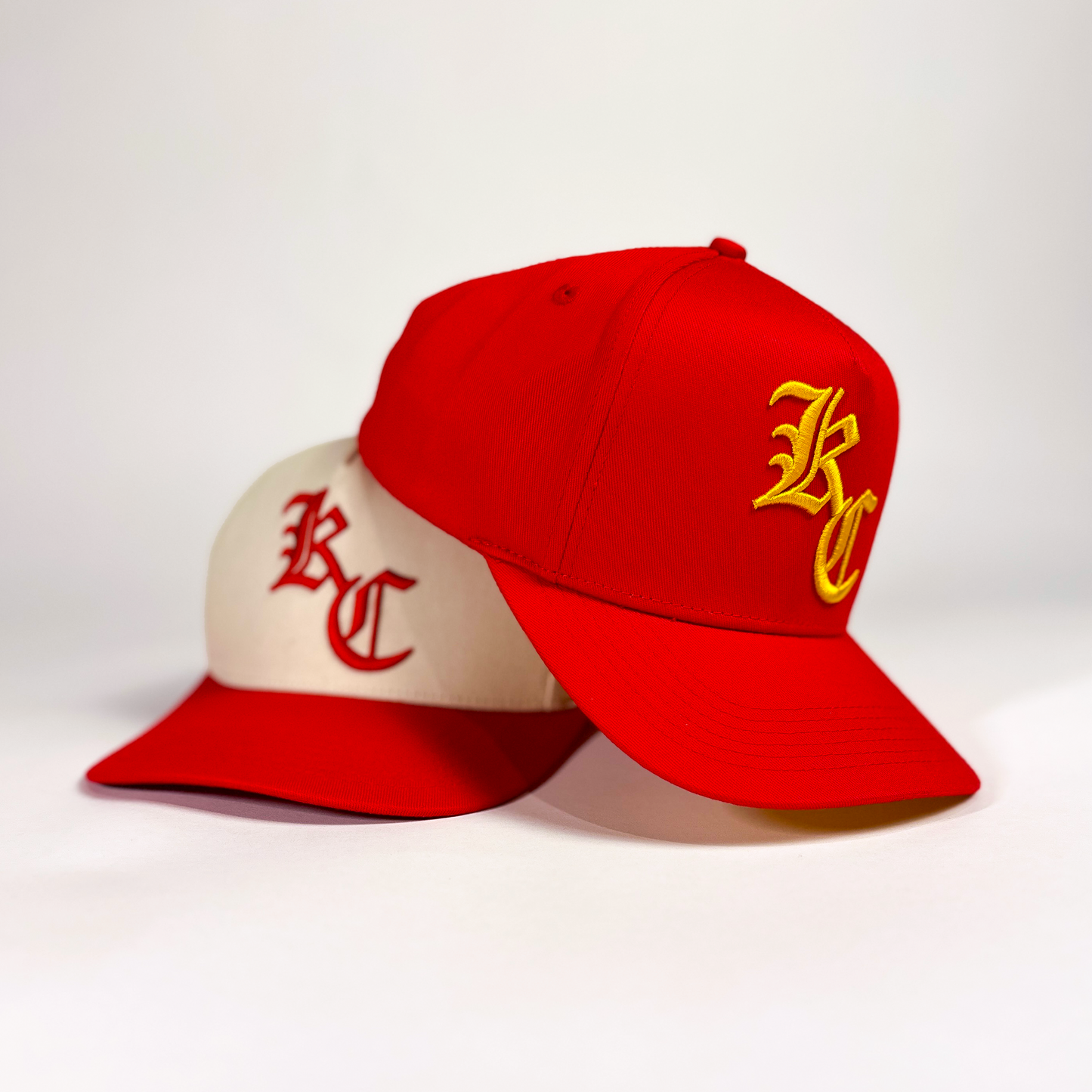 Red and off-white snapback hat with puff embroidery of an old english style KC. Also available in Red with yellow embroidery. 'Chrome Kingdom Hat' by Always Outside