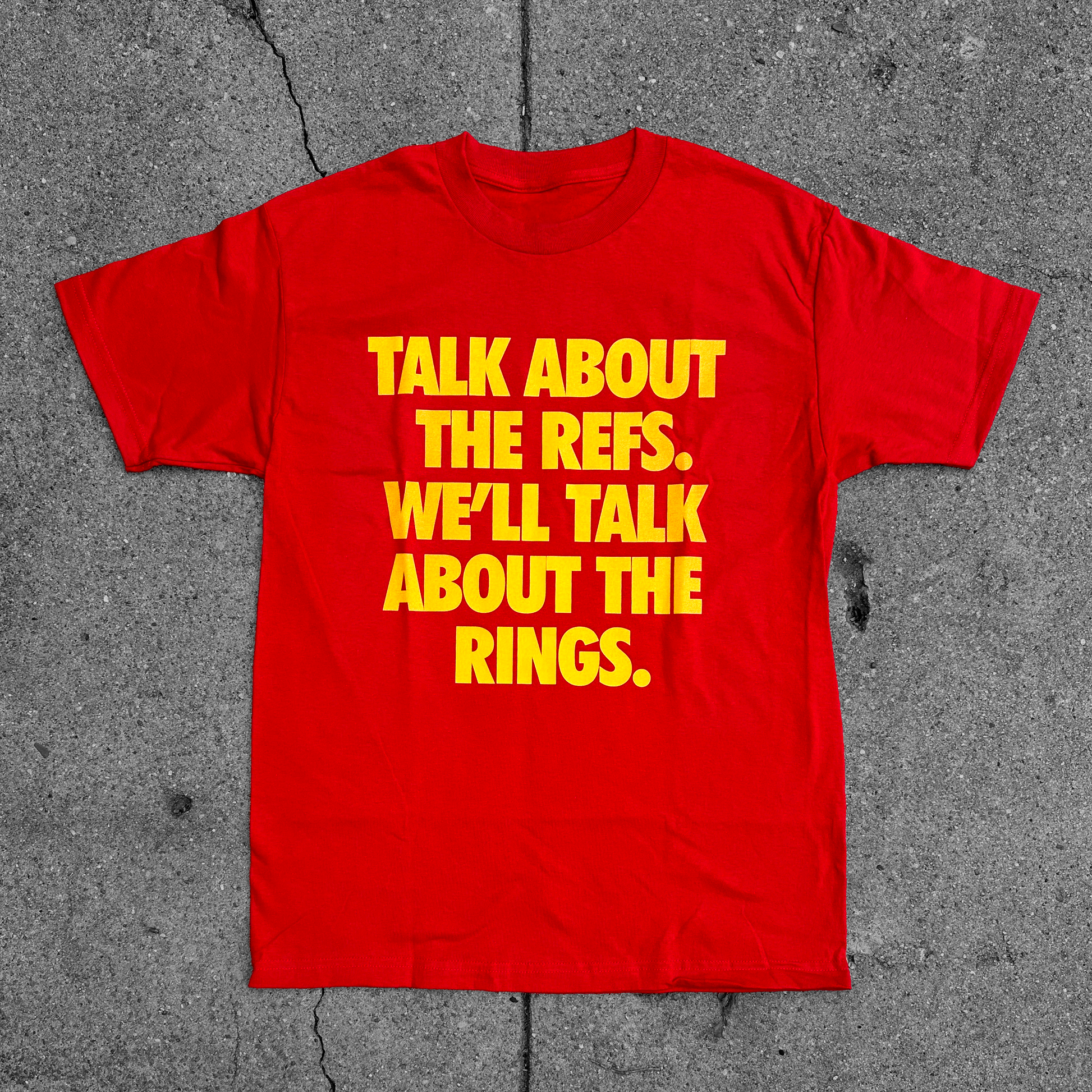 Red t-shirt with 'Talk About the Refs, We'll Talk About the Rings' screen-printed graphic by Always Outside